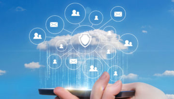 Hand holding mobile phone projecting icons in a cloud formation