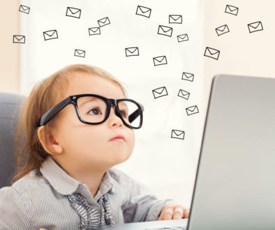 Email concept with toddler girl using her laptop